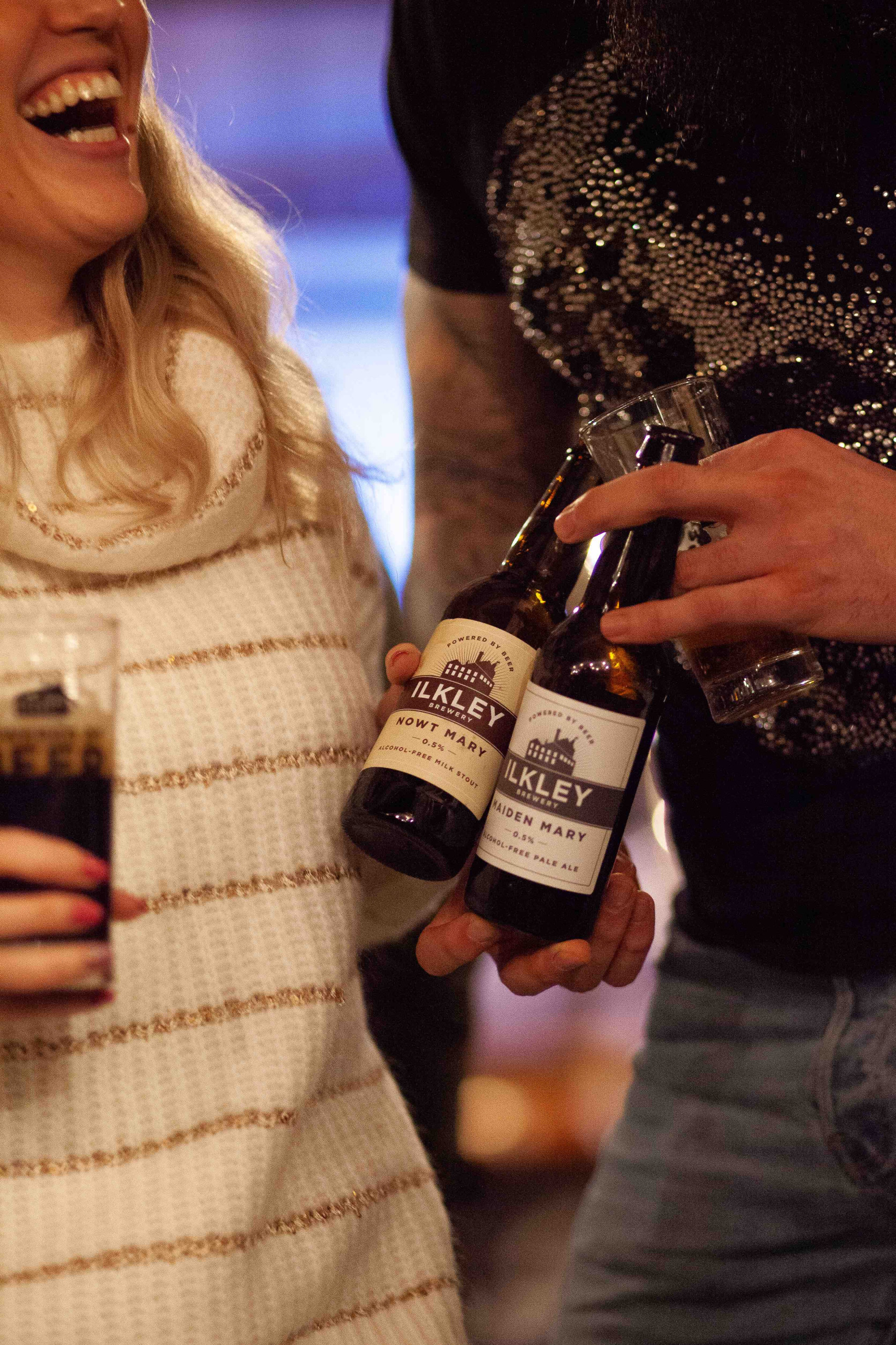 People holding beer bottles