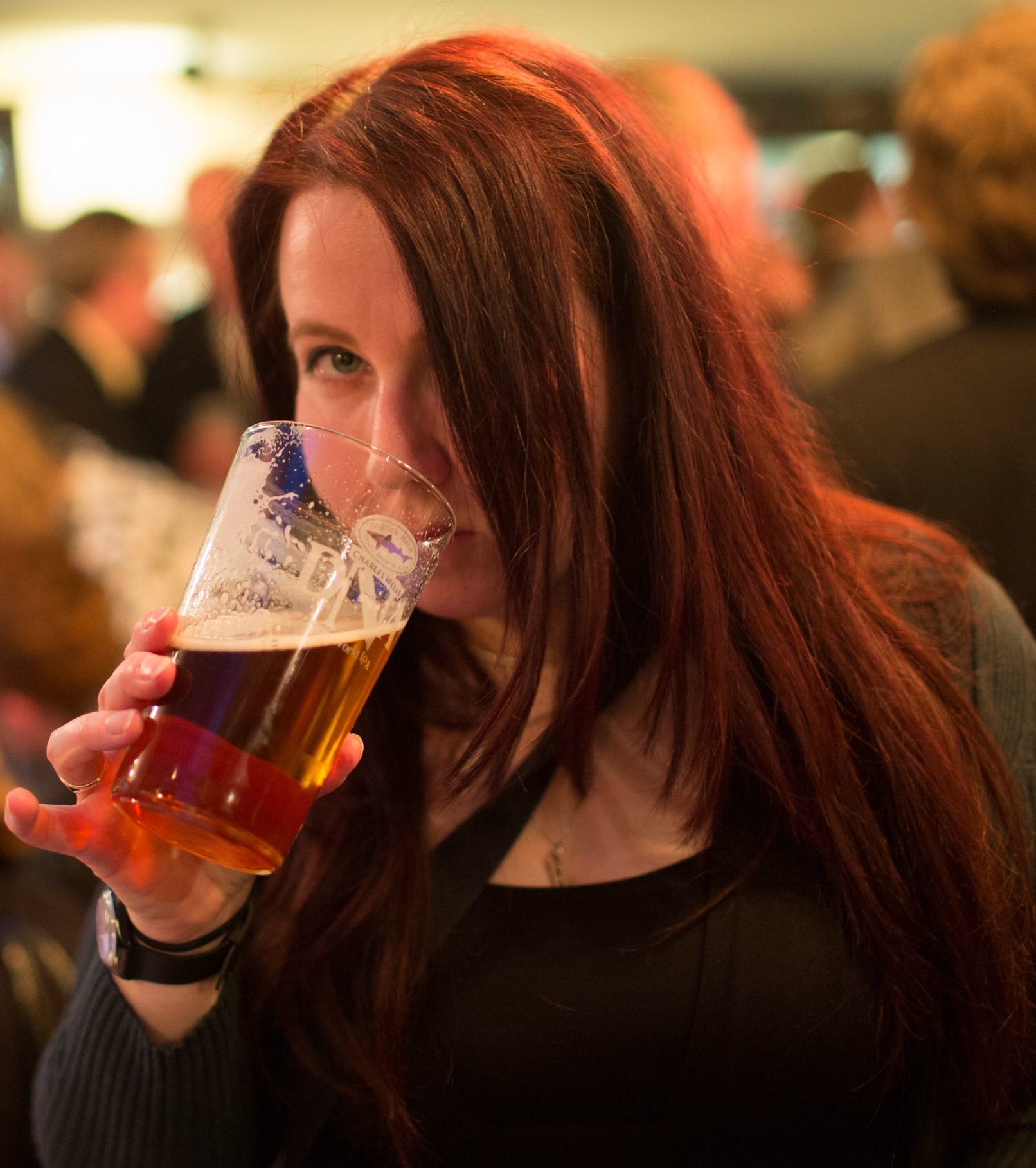A woman drinking a pint of cask ale