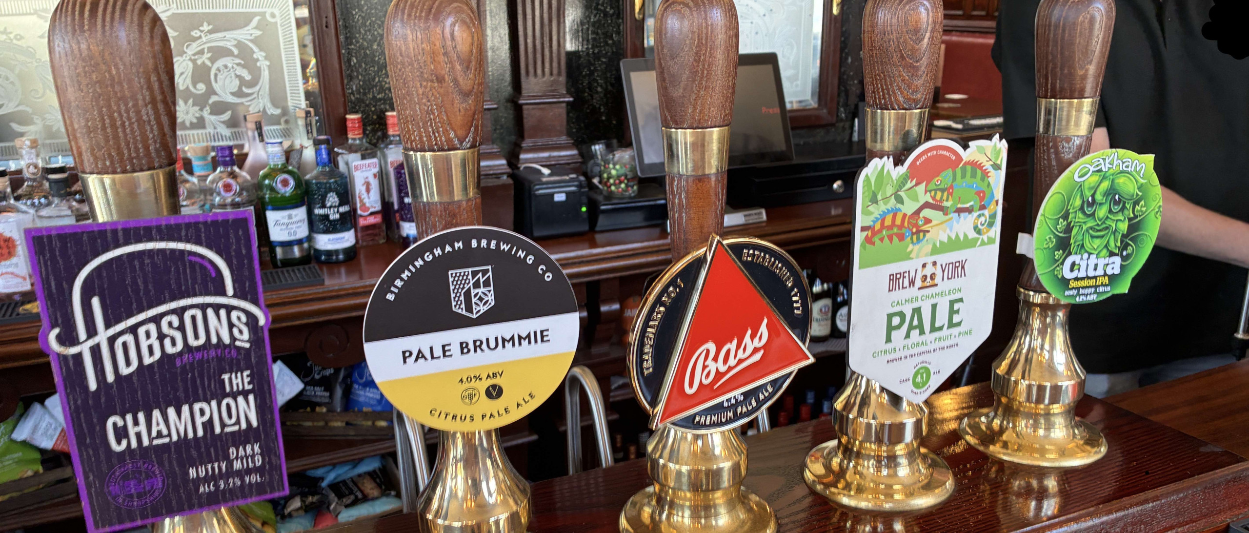 A picture of handpumps on a pub bar